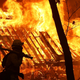 A Cal Fire firefighter monitors a burning home as the Camp Fire moves through Magalia, California on Nov. 9, 2018.